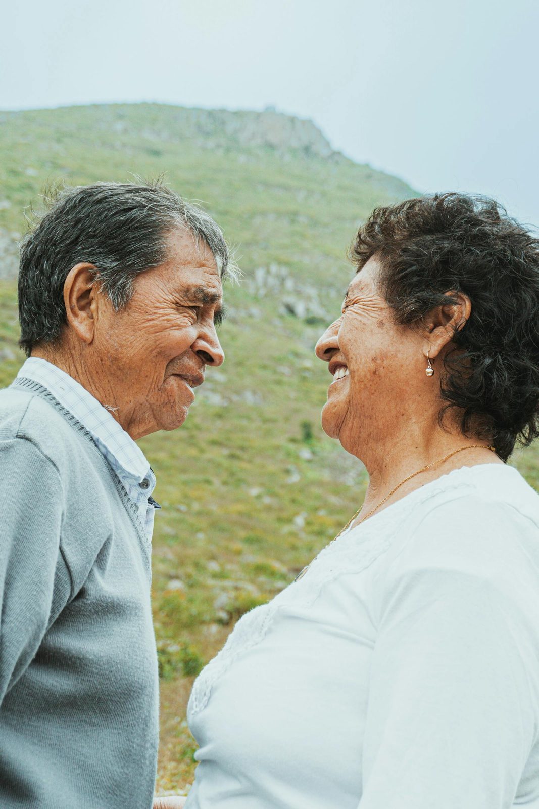 Ecuadorian couple aged 40 to 65 in front of their home